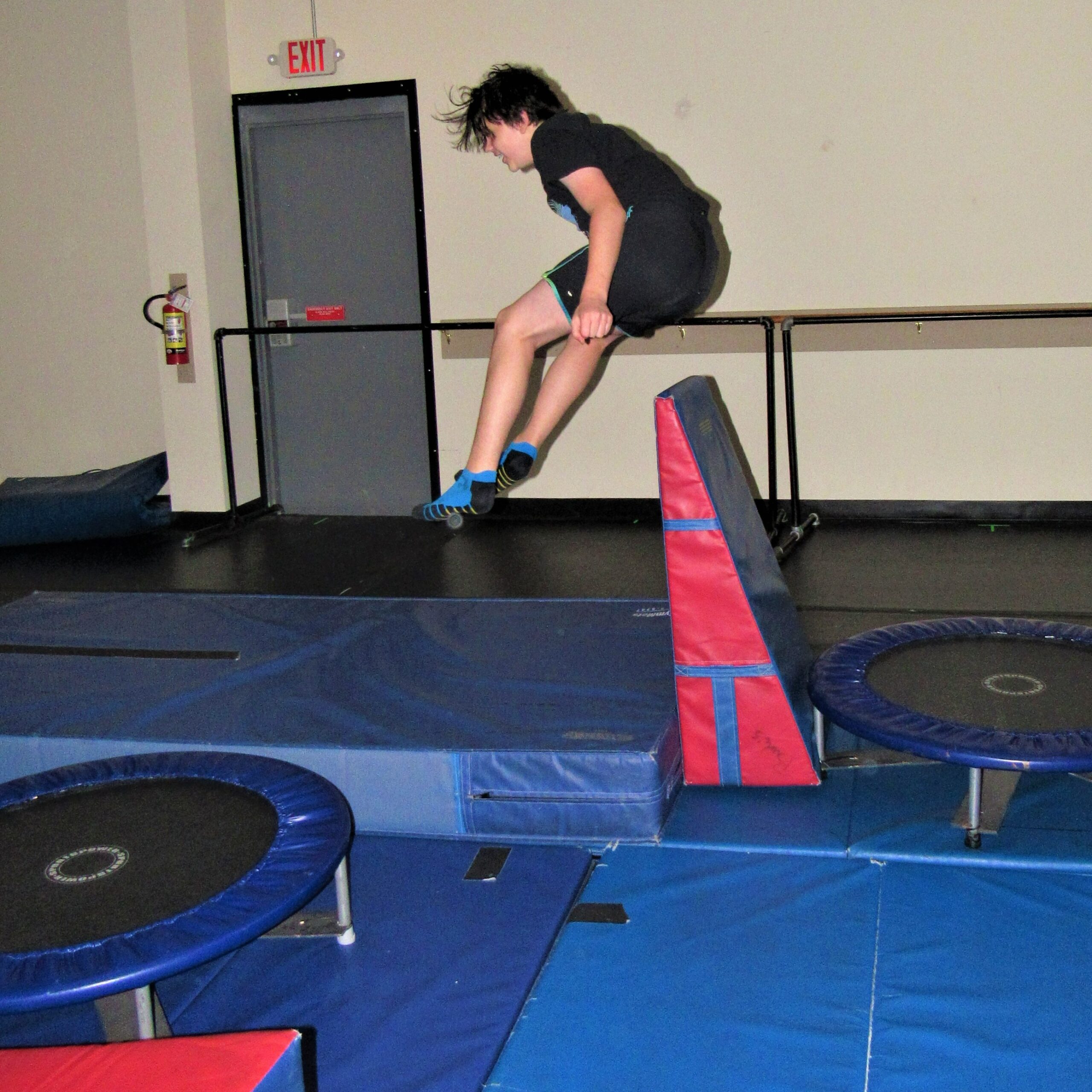 Boy jumping over obstacle
